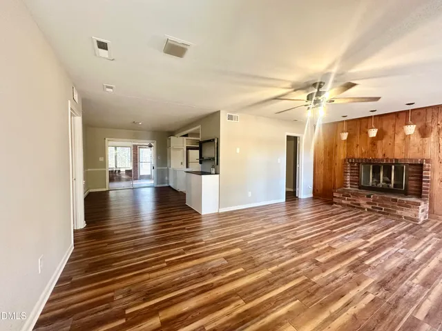 a view of a room with wooden floor
