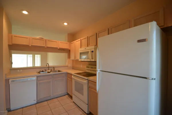 a kitchen with a sink a refrigerator and window