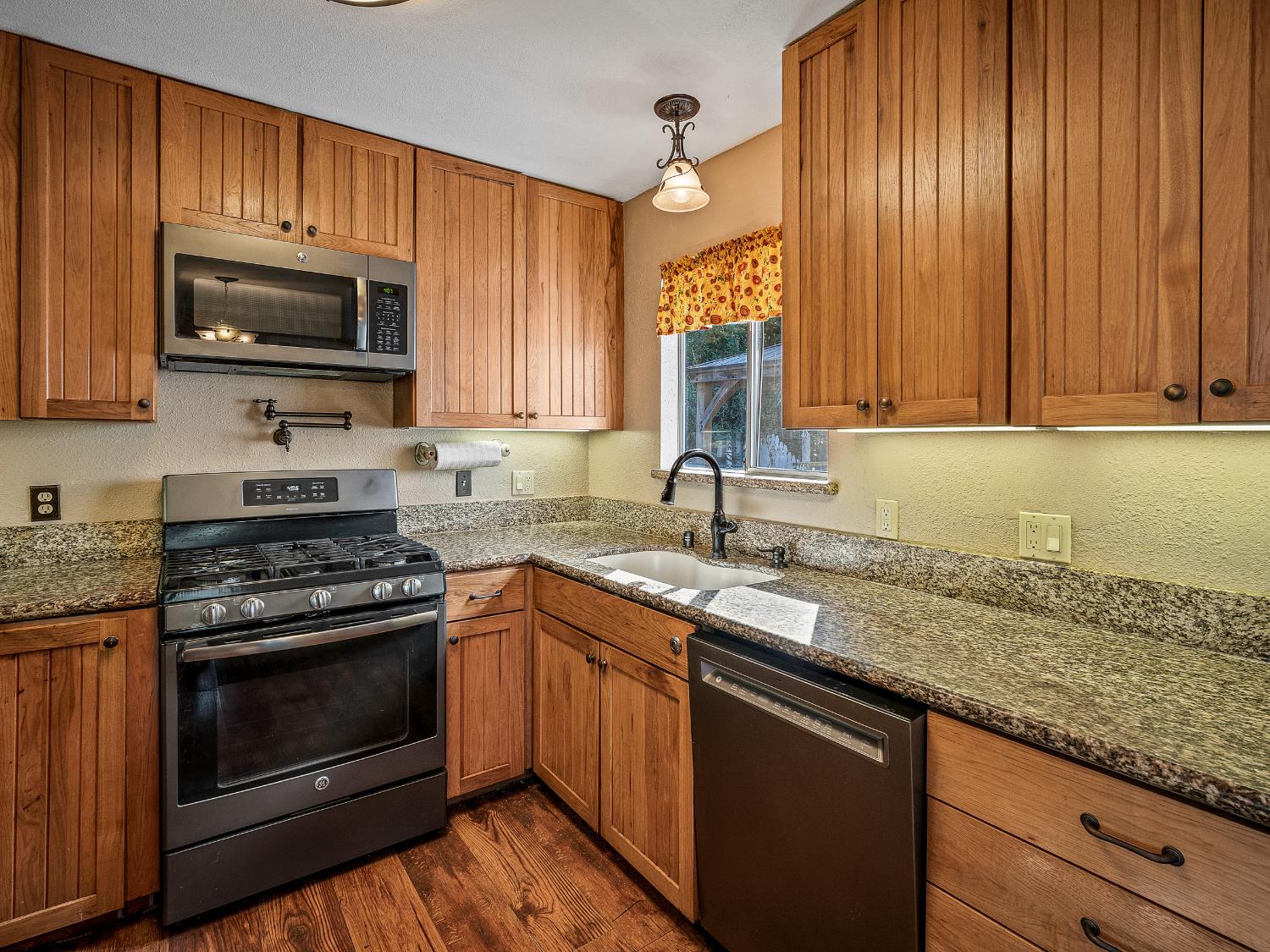 6800 Diablo View Trail Placerville, CA 95667 - Photo 28 of 33 a kitchen with granite countertop stainless steel appliances a stove a sink and a microwave