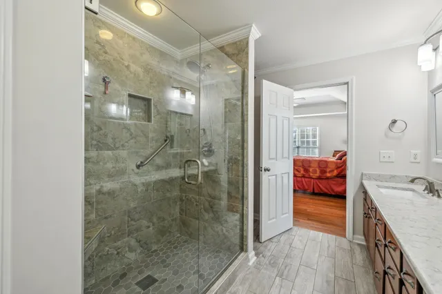 a bathroom with a tub shower and sink