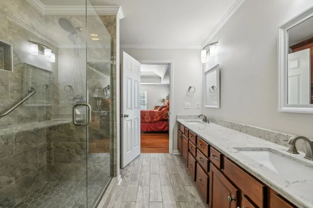 a en suite bathroom with double vanity and a shower