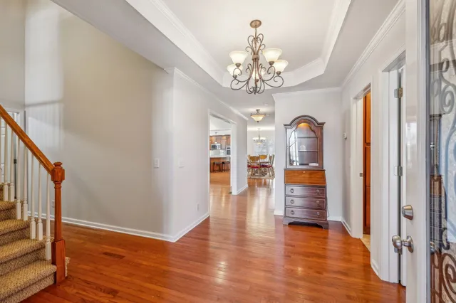 a view of a livingroom with wooden floor and staircase