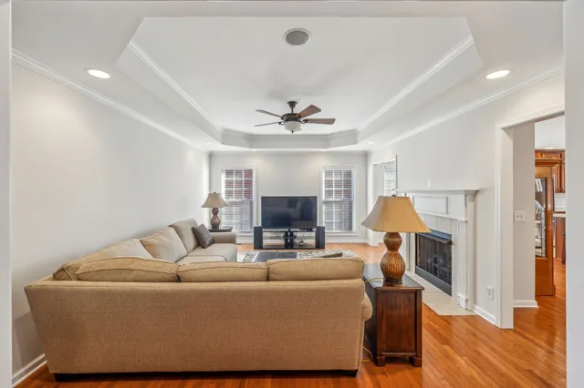 a living room with furniture and a wooden floor