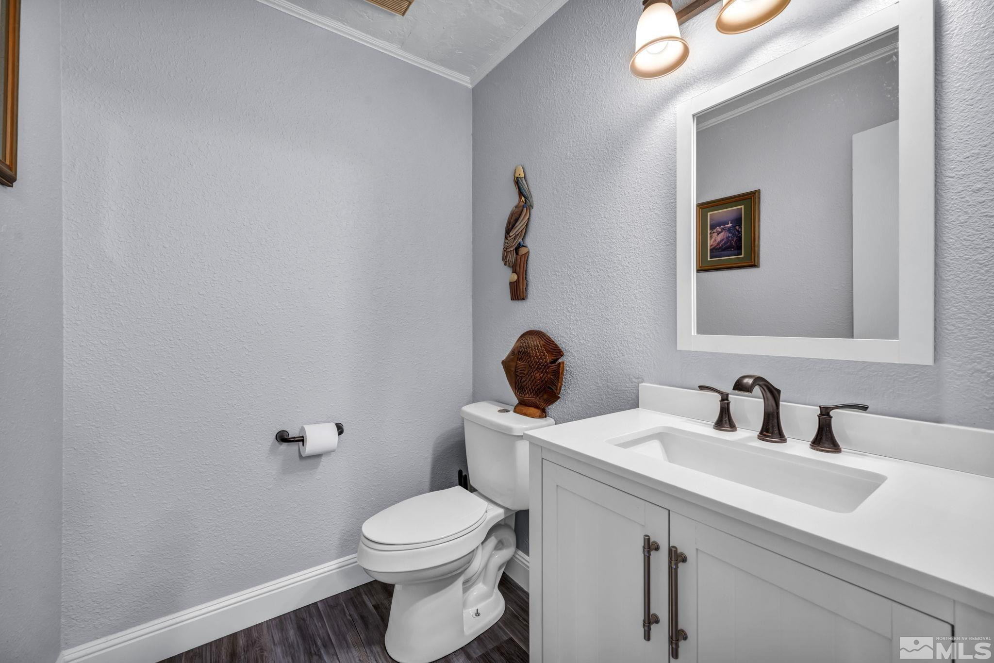 4721 Reggie Road Reno, NV 89502 - Photo 14 of 33 a bathroom with a toilet sink and mirror