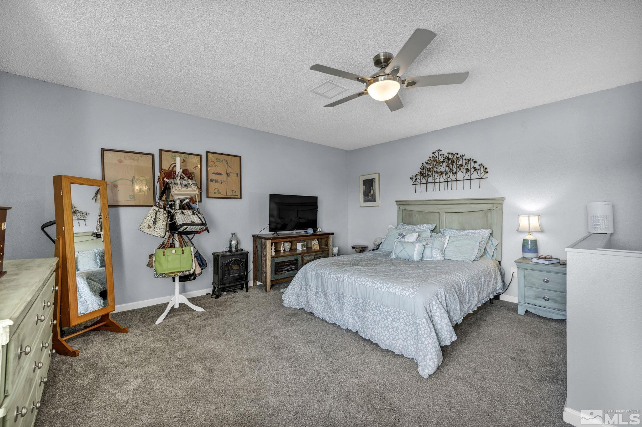 4721 Reggie Road Reno, NV 89502 - Photo 17 of 33 a bedroom with a bed and a view of living room