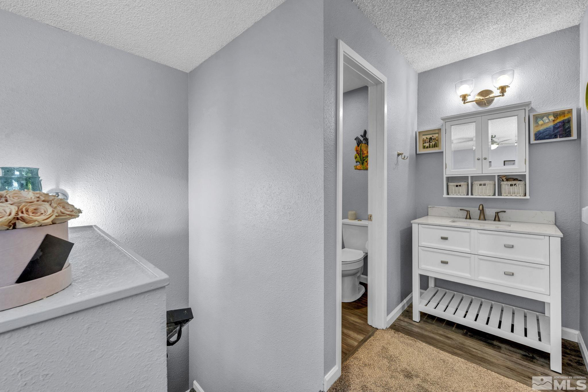 4721 Reggie Road Reno, NV 89502 - Photo 19 of 33 a bedroom with a bed and a dresser in it