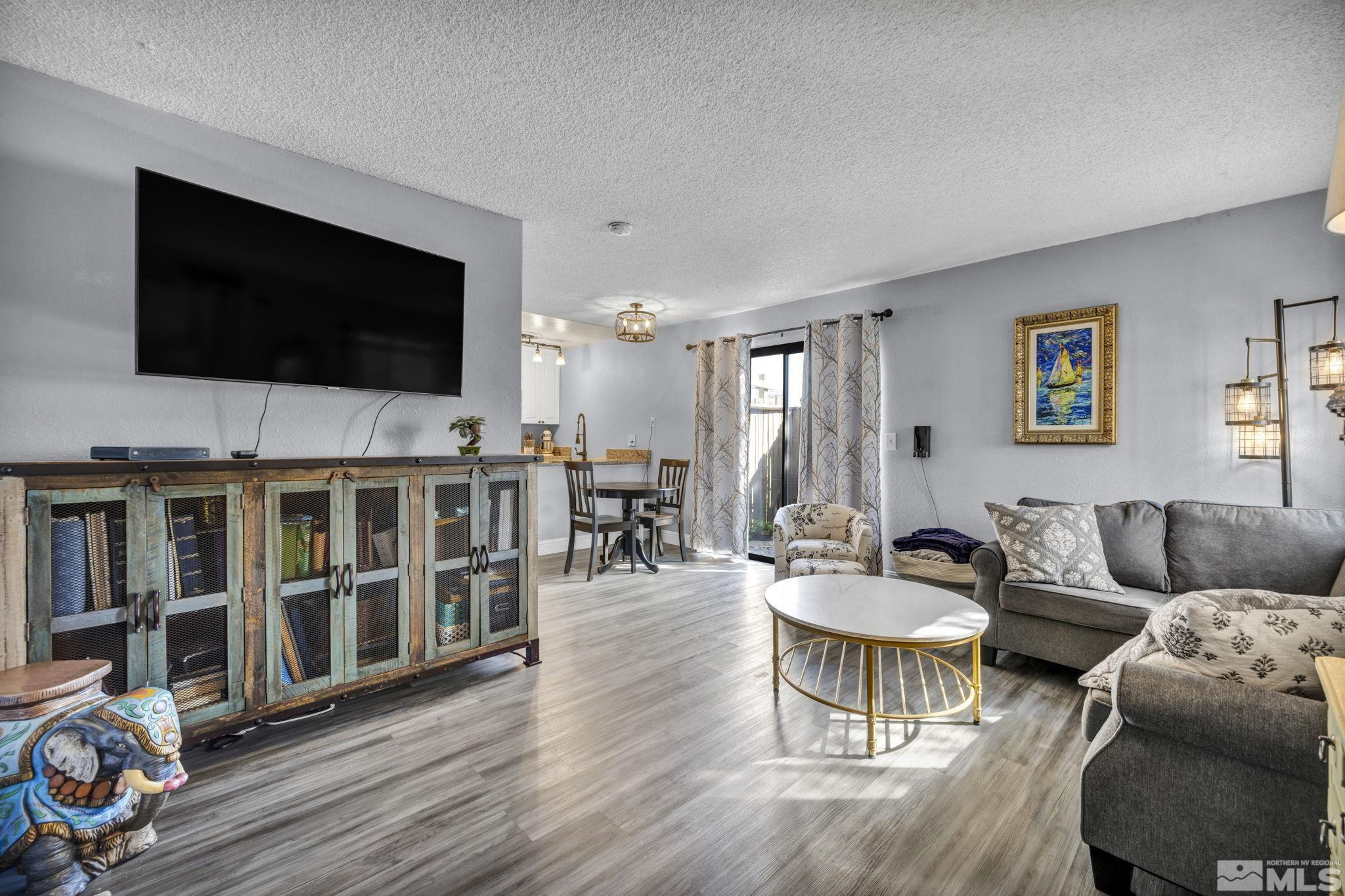 4721 Reggie Road Reno, NV 89502 - Photo 3 of 33 a living room with furniture and a flat screen tv