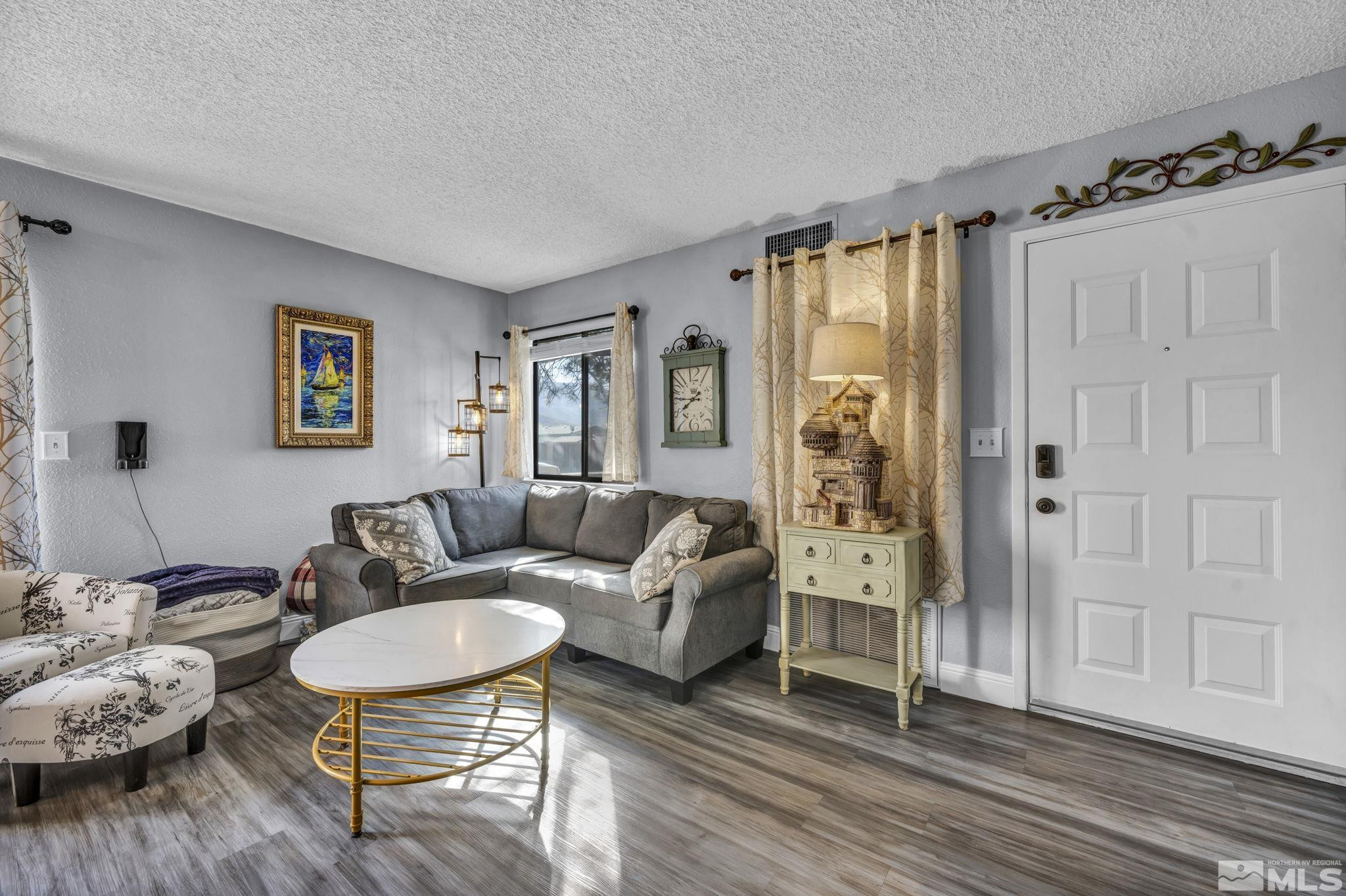 4721 Reggie Road Reno, NV 89502 - Photo 4 of 33 a living room with furniture and a wooden floor