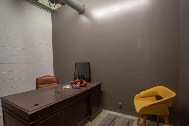 a blue swimming pool with a glass top table and chair