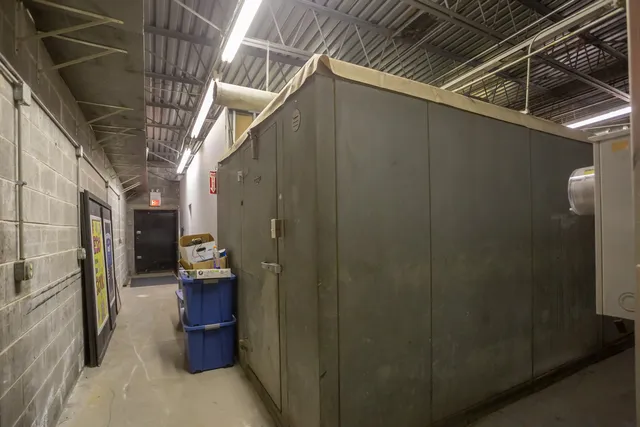 a kitchen with a sink and wooden floor