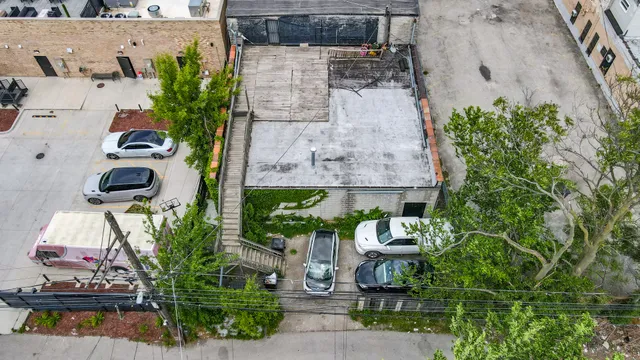 an aerial view of a house with a yard and sitting area