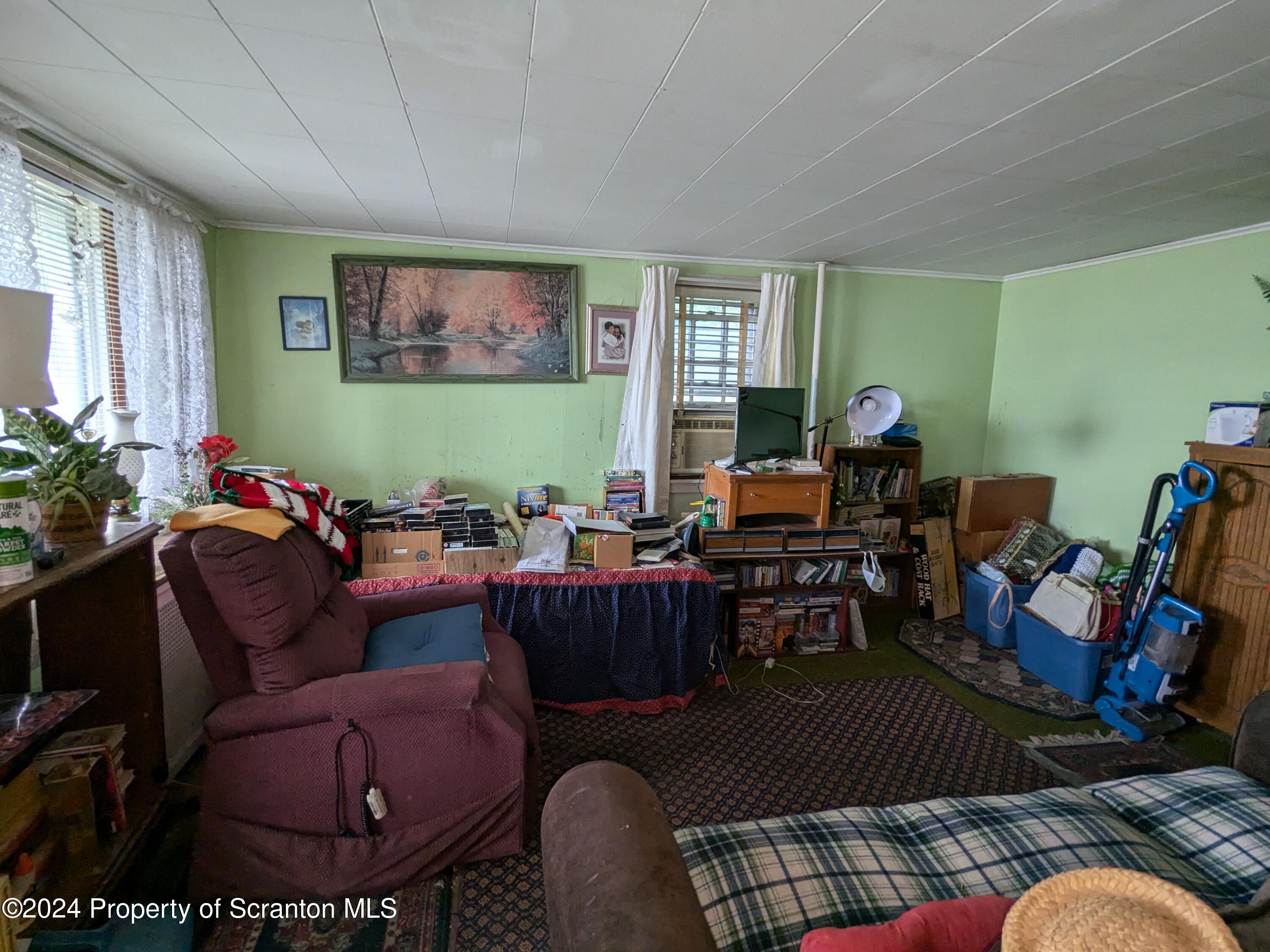 909 Battle Street Scranton, PA 18508 - Photo 2 of 11 a living room with furniture potted plant and a window