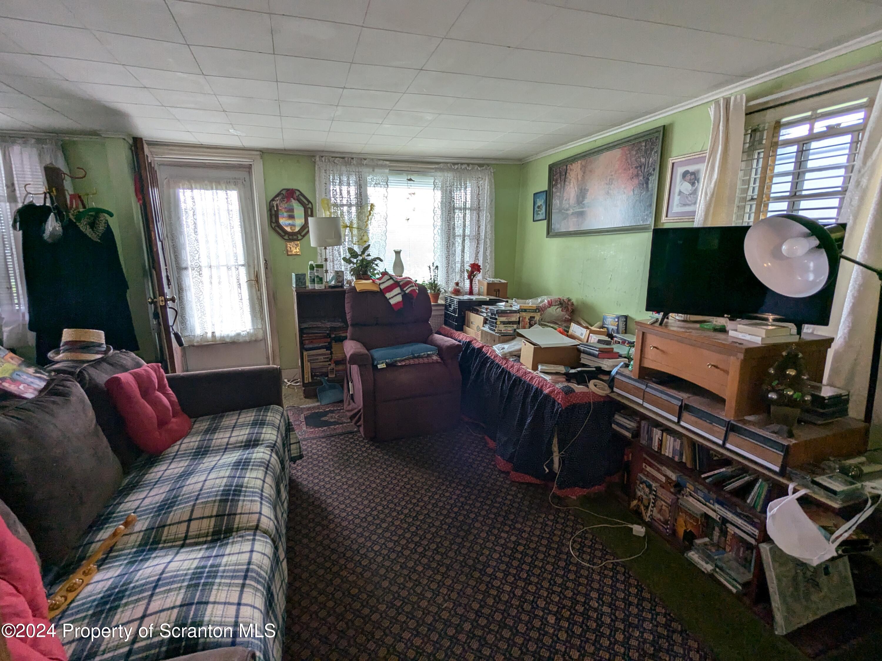 909 Battle Street Scranton, PA 18508 - Photo 3 of 11 a living room with furniture a window and a flat screen tv