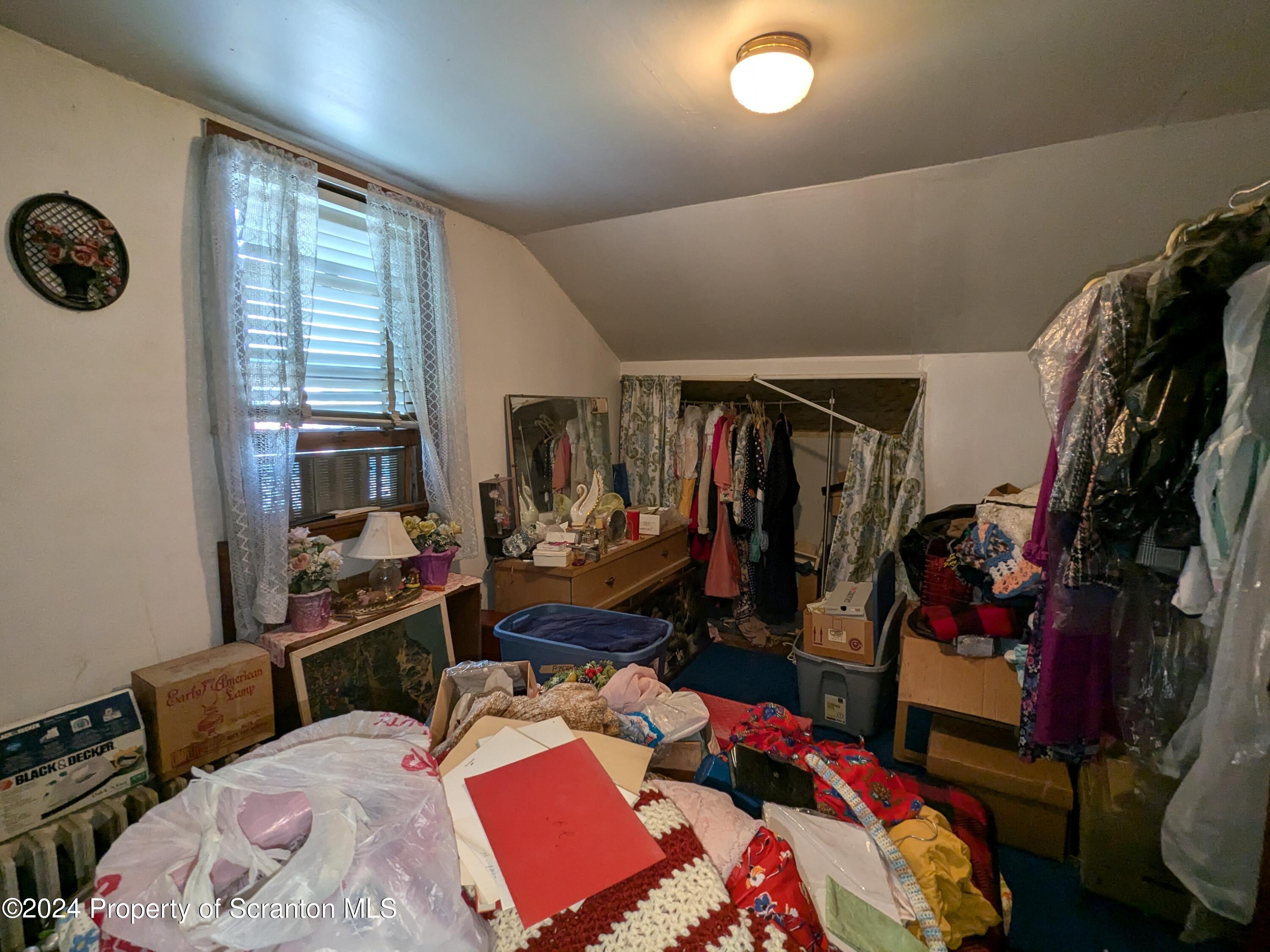 909 Battle Street Scranton, PA 18508 - Photo 9 of 11 a bedroom with a bed and a window