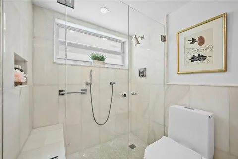 a bathroom with a granite countertop sink a toilet and bathtub