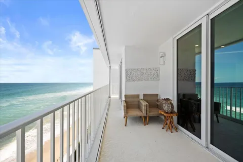 a view of a balcony with chairs