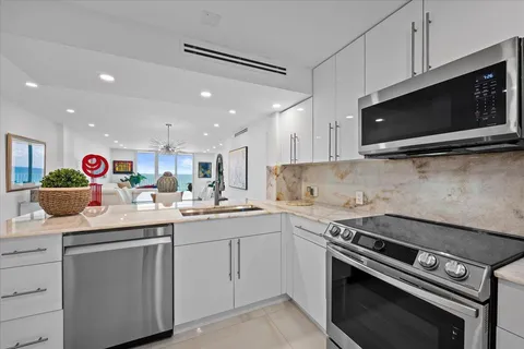 a kitchen with a sink stove and microwave
