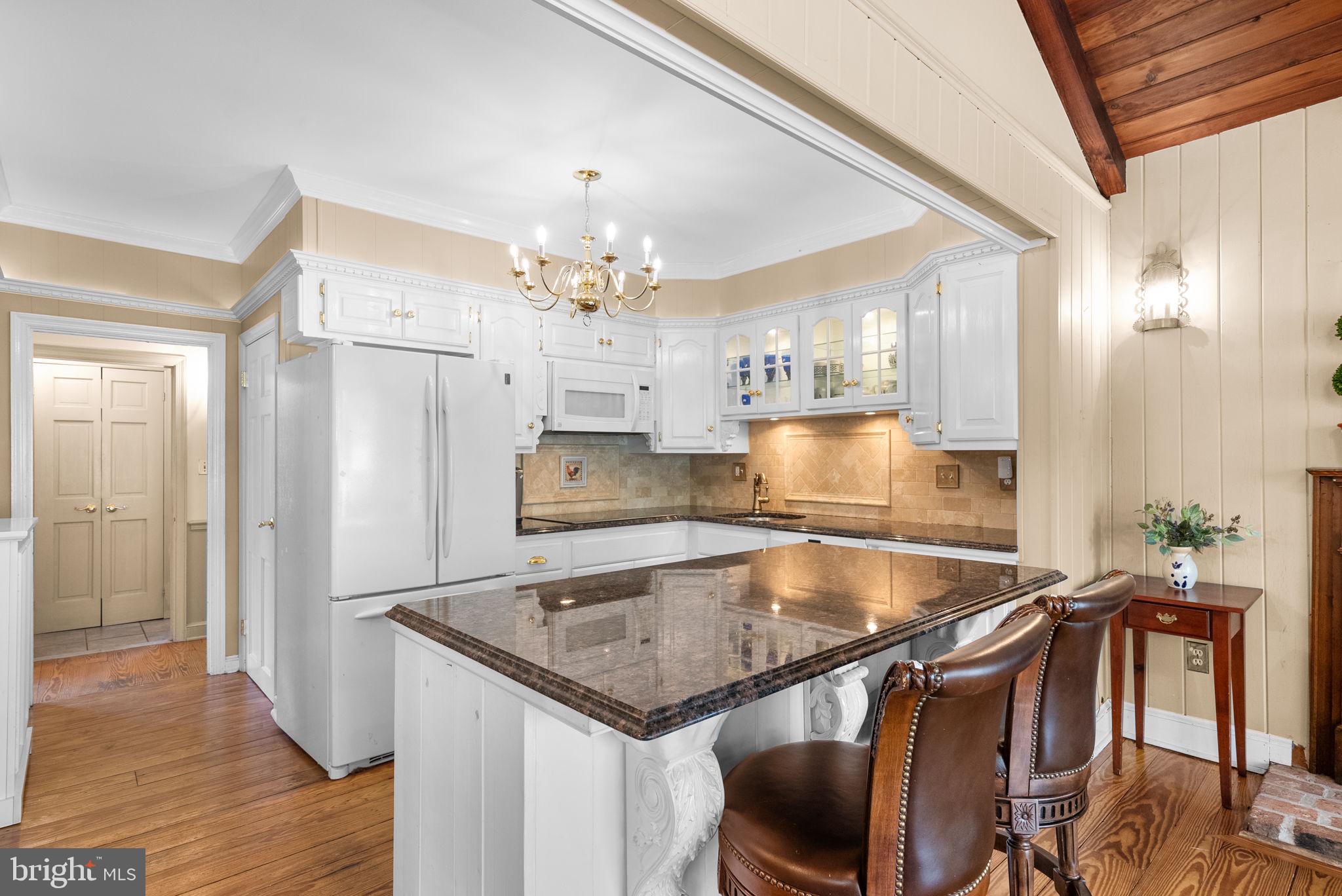 801 Notley Road Silver Spring, MD 20904 - Photo 14 of 42 a kitchen with a table chairs and refrigerator