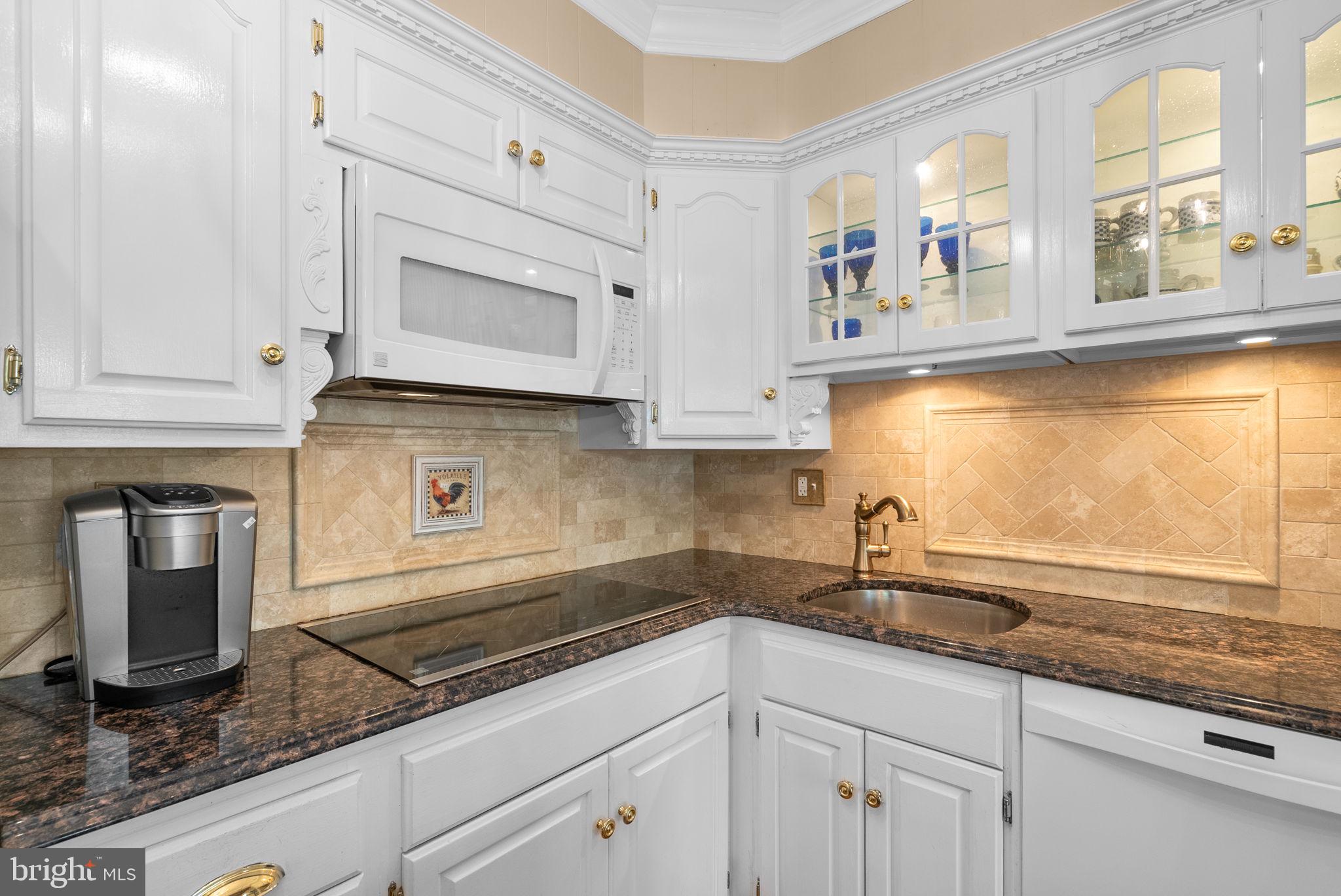 801 Notley Road Silver Spring, MD 20904 - Photo 15 of 42 a kitchen with stainless steel appliances granite countertop white cabinets and window