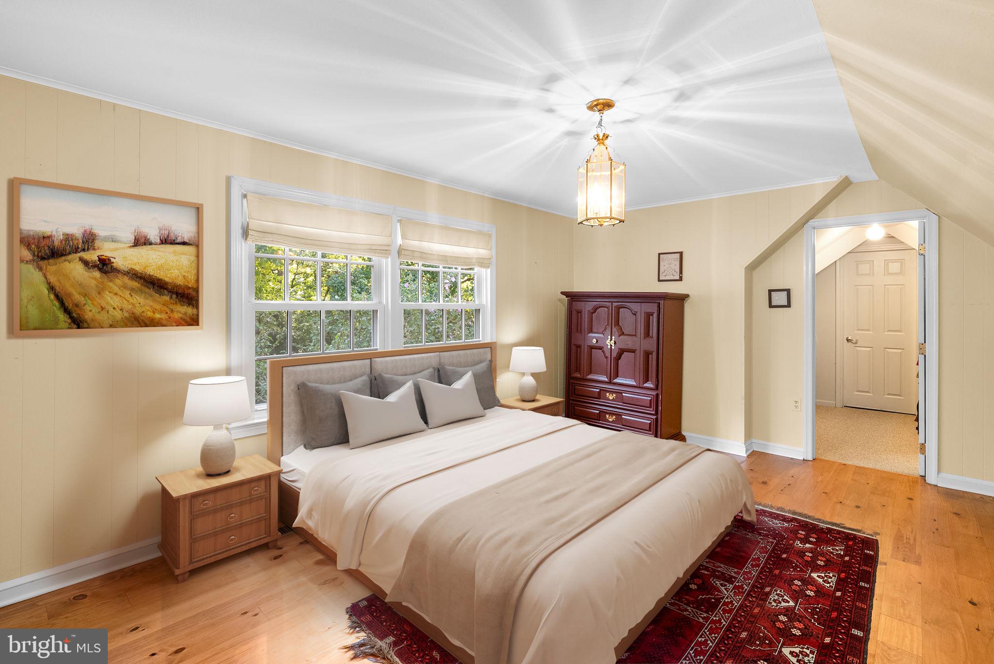 801 Notley Road Silver Spring, MD 20904 - Photo 25 of 42 a bedroom with a large bed a chandelier and dresser