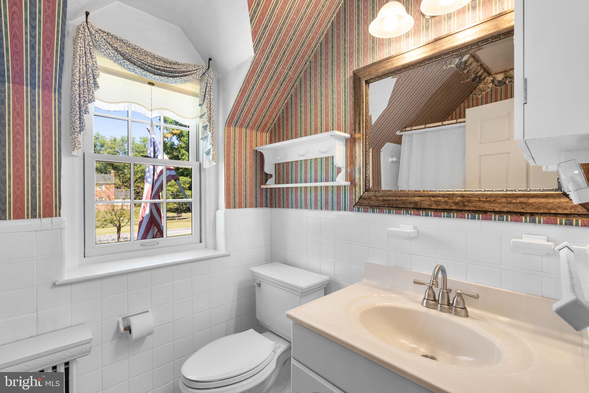 801 Notley Road Silver Spring, MD 20904 - Photo 32 of 42 a bathroom with a sink a mirror and a toilet