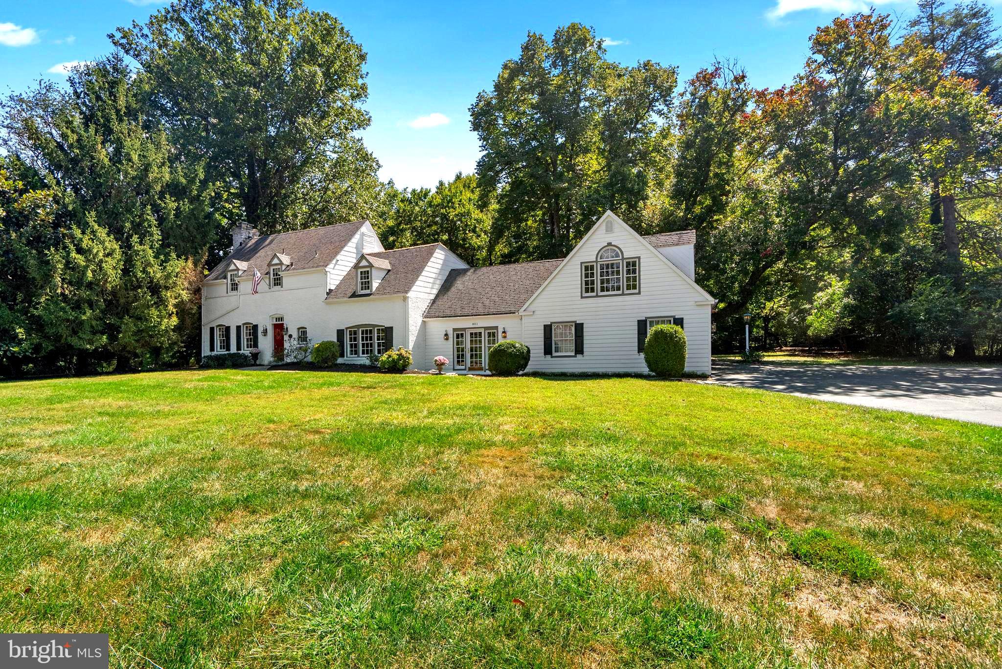 801 Notley Road Silver Spring, MD 20904 - Photo 4 of 42 a view of a white house with a big yard and large trees