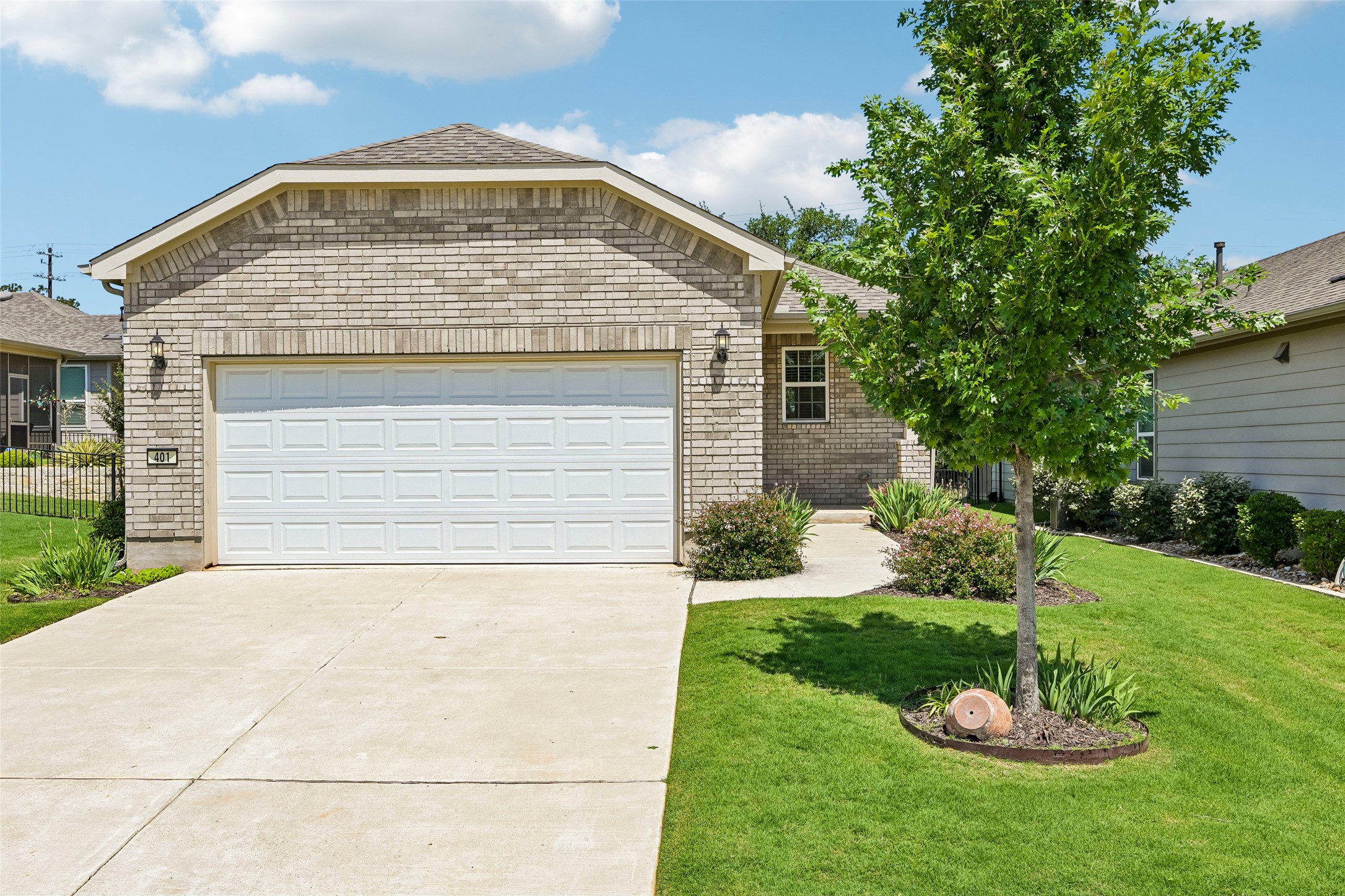 401 Yorktown Street Georgetown, TX 78633 - Photo 1 of 38 Exterior featuring light-colored brick, a two-car garage, and a concrete driveway
