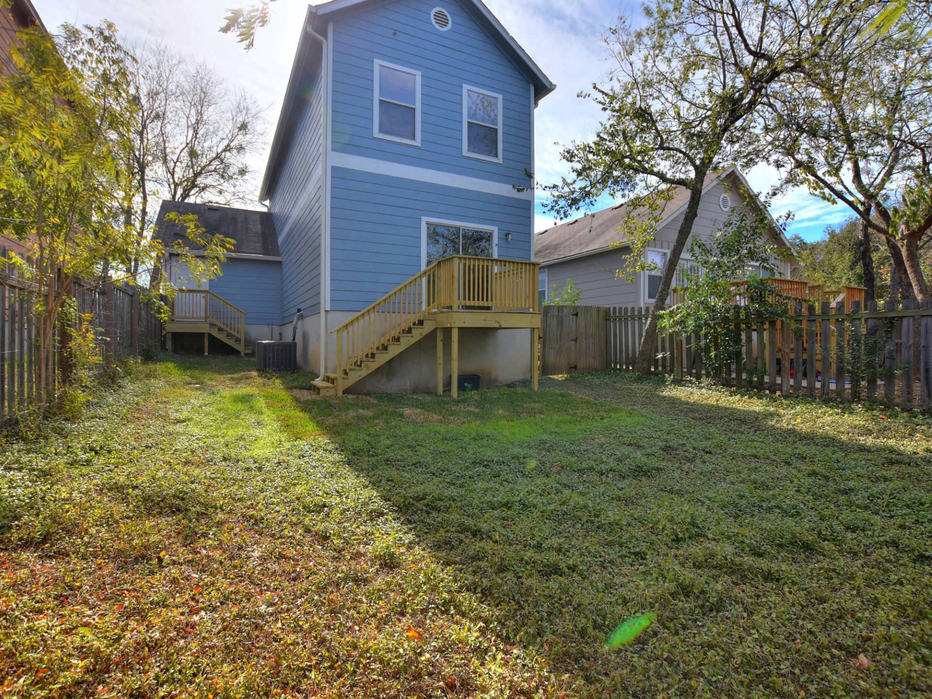 917 East 3rd Street Georgetown, TX 78626 - Photo 20 of 23 A well-maintained yard provides ample space for outdoor activities, complete with private decks off the structure.