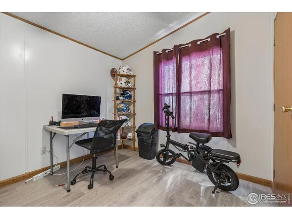 a view of a workspace with furniture and a window