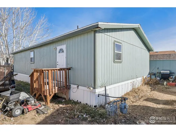a backyard of a house with table and chairs