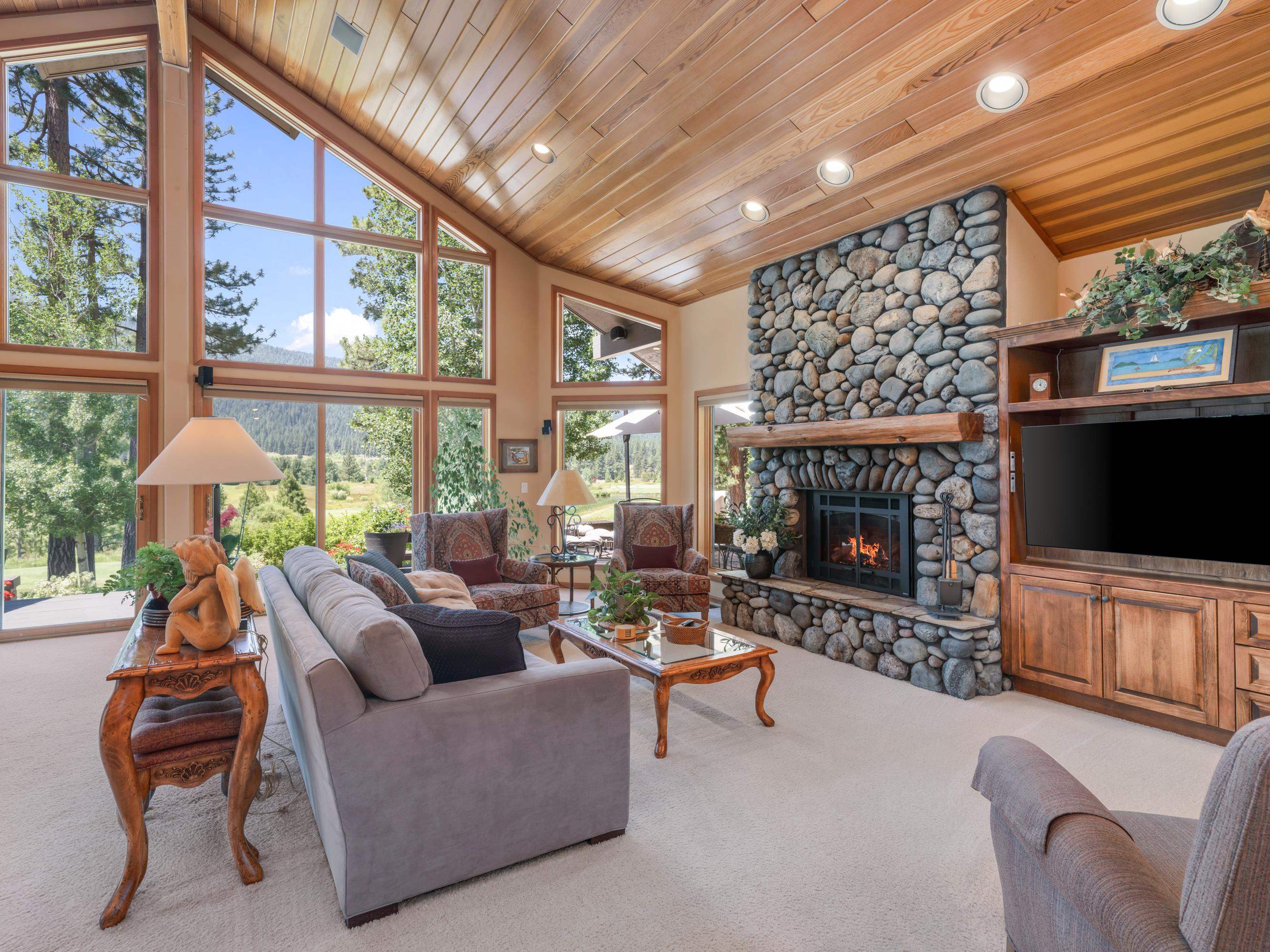 134 Quail View Circle Clio, CA 96106 - Photo 9 of 49 a living room with furniture a flat screen tv and a fireplace