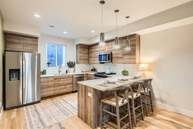 a kitchen with a stove a refrigerator and a sink