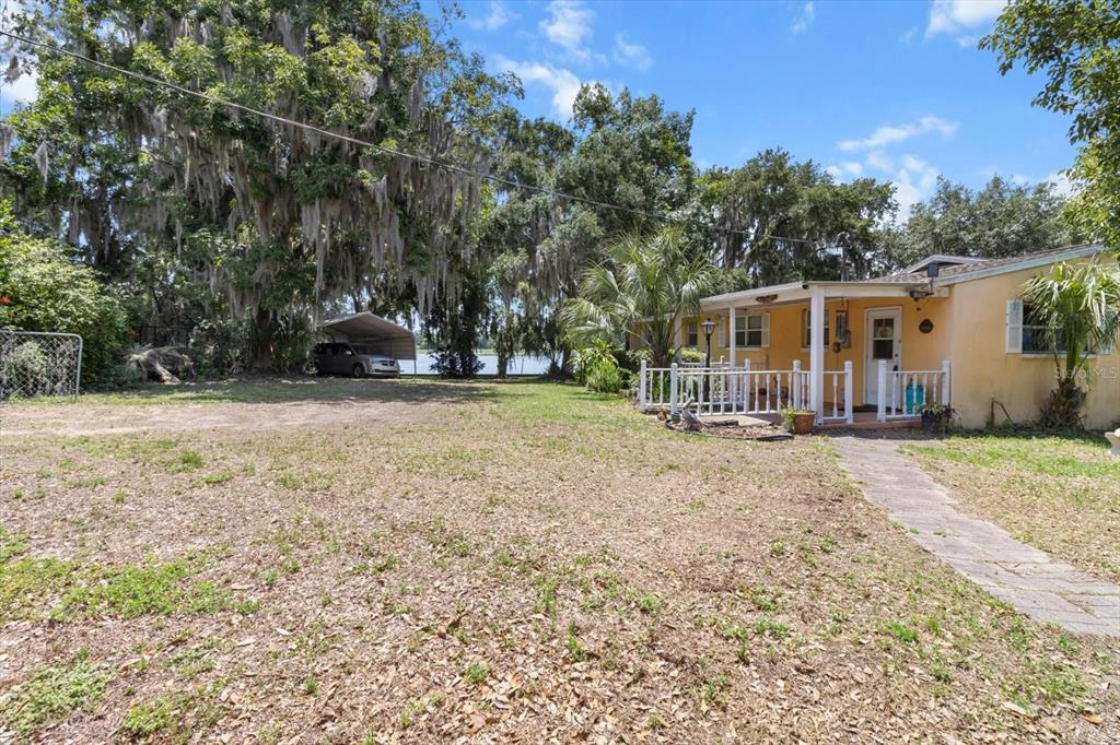 1226 South Telephone Point Road Inverness, FL 34450 - Photo 17 of 43 a backyard of a house with yard and outdoor seating
