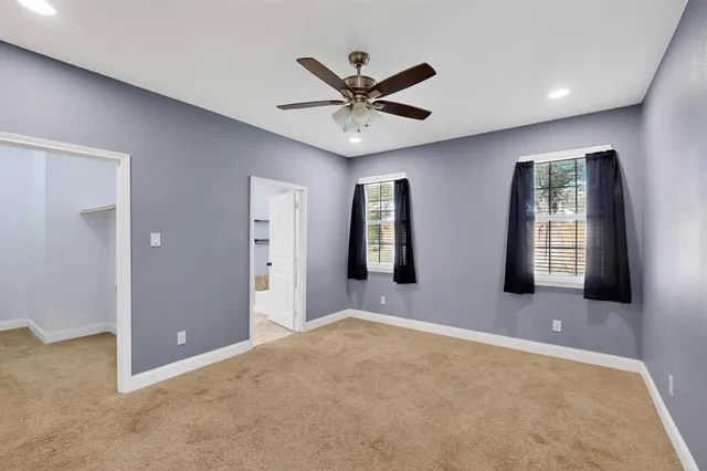 a view of a livingroom with a ceiling fan and window