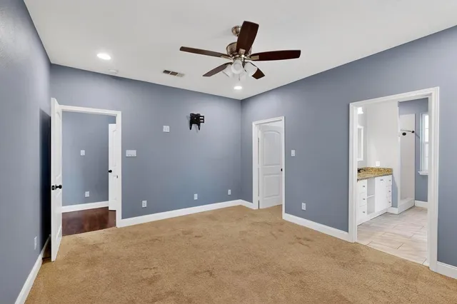 an empty room and chandelier fan