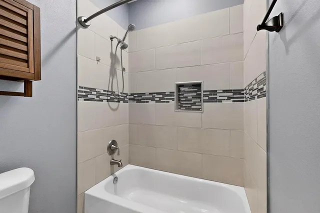 a bathroom with a shower a mirror and a sink