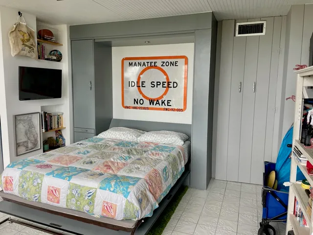 a bedroom with a bed and a flat screen tv