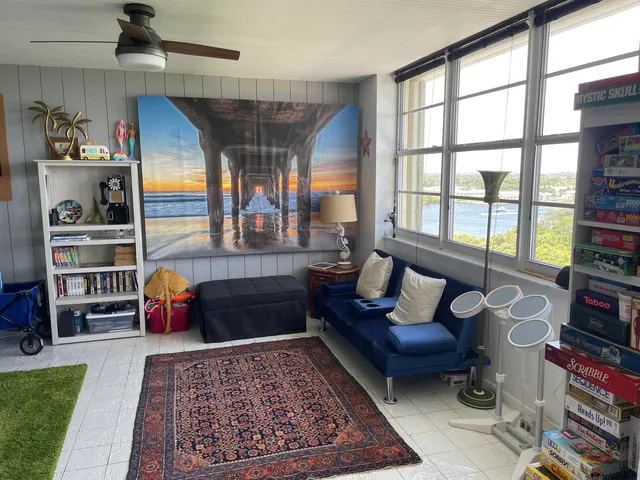 a living room with furniture toys and a rug