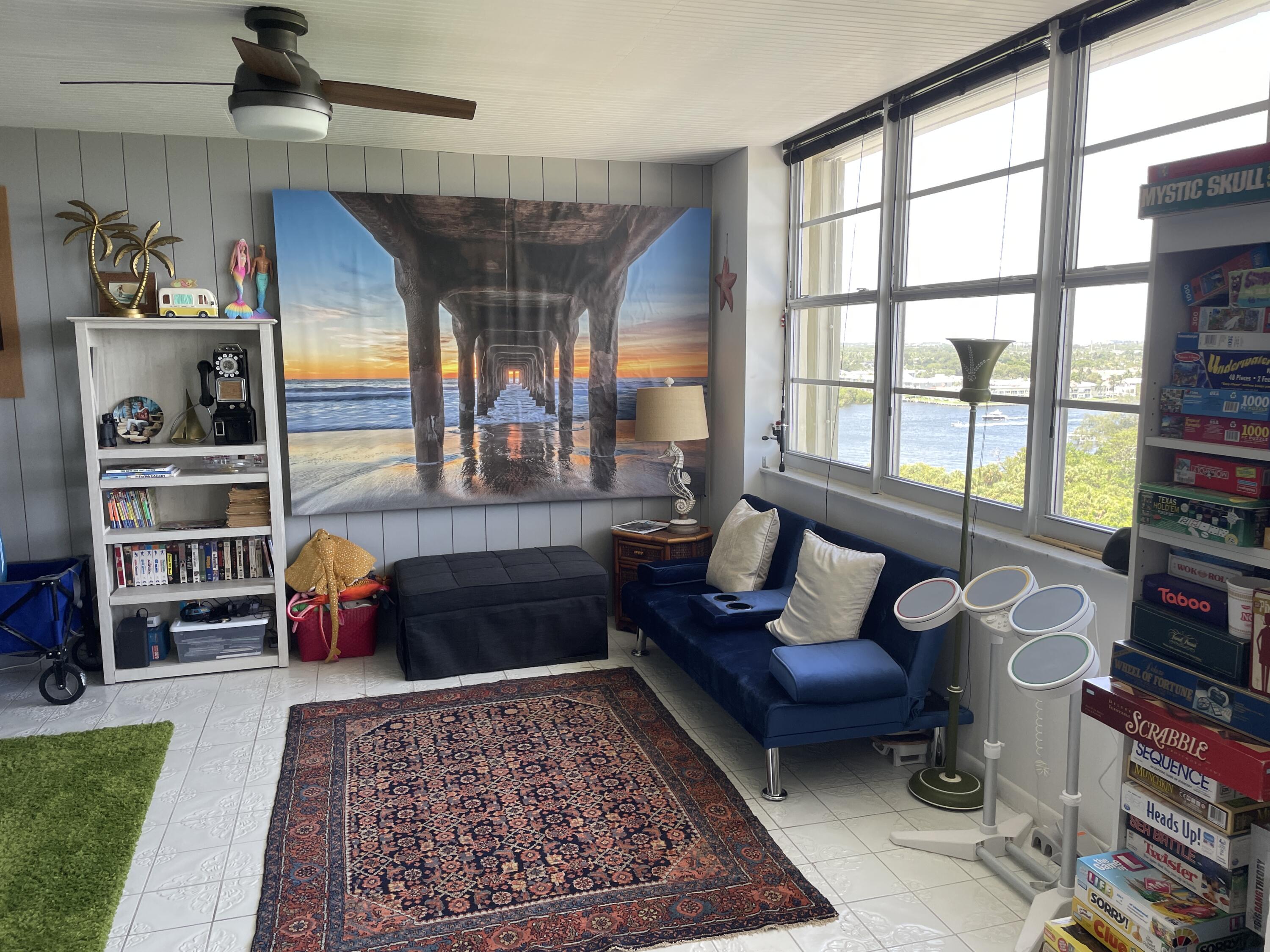 2121 North Ocean Boulevard, Unit 1204E Boca Raton, FL 33431 - Photo 17 of 21 a living room with furniture toys and a rug