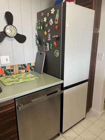 a kitchen with a refrigerator and cabinets