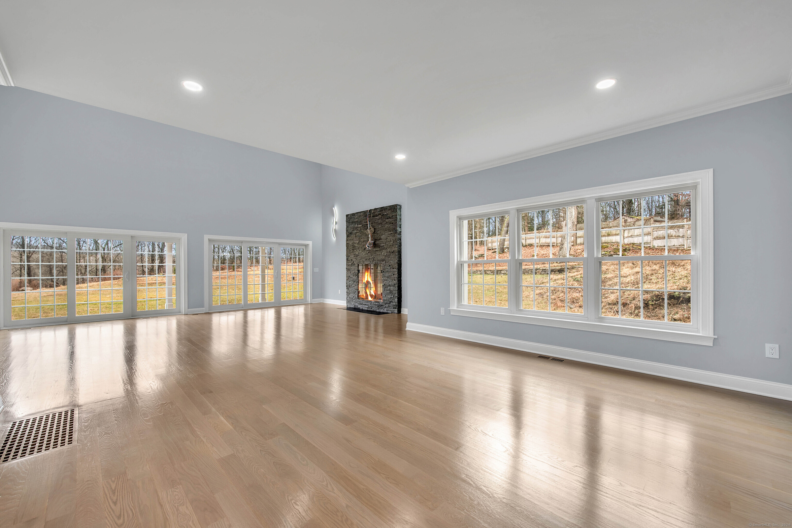 34 Fox Run Road Redding, CT 06896 - Photo 16 of 40 an empty room with wooden floor and windows