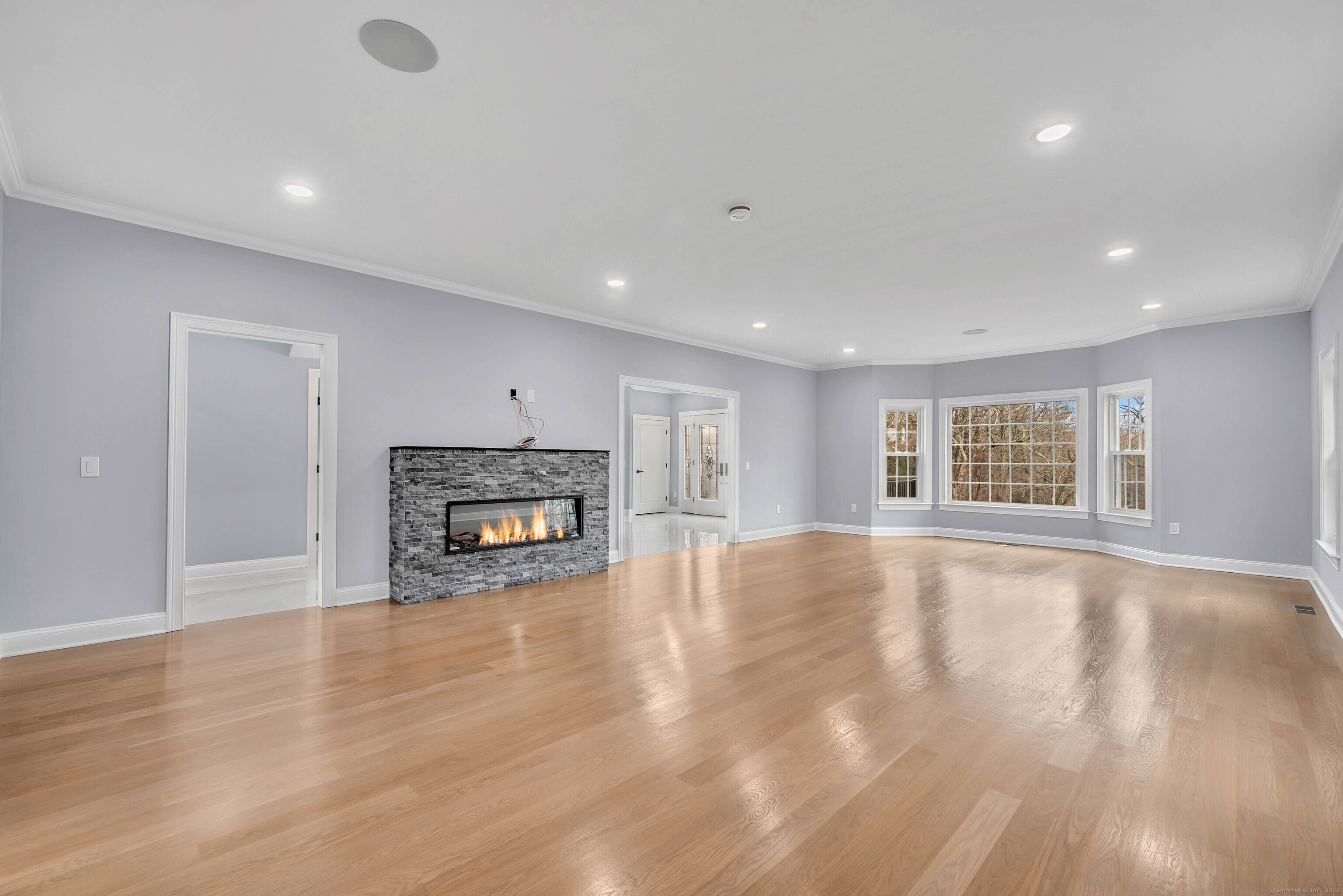 34 Fox Run Road Redding, CT 06896 - Photo 20 of 40 an empty room with wooden floor and a fireplace