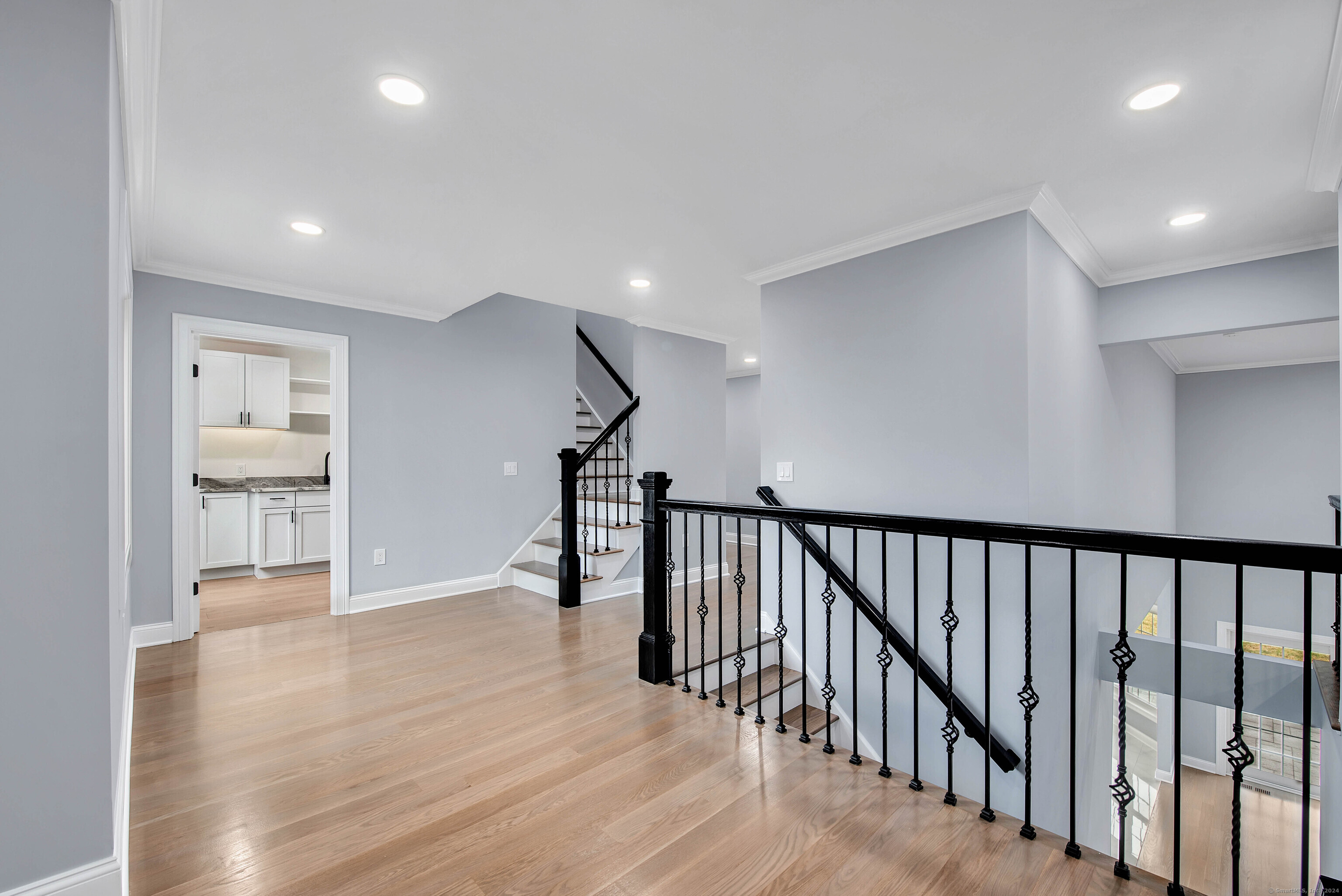 34 Fox Run Road Redding, CT 06896 - Photo 26 of 40 a view of a hallway with wooden floor and staircase