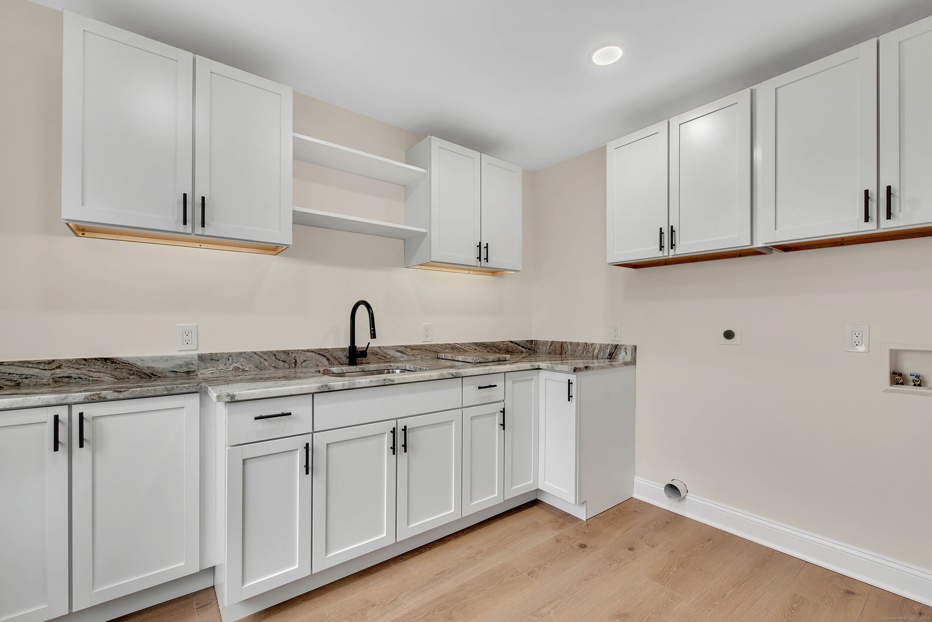 34 Fox Run Road Redding, CT 06896 - Photo 27 of 40 a kitchen with granite countertop white cabinets and a sink