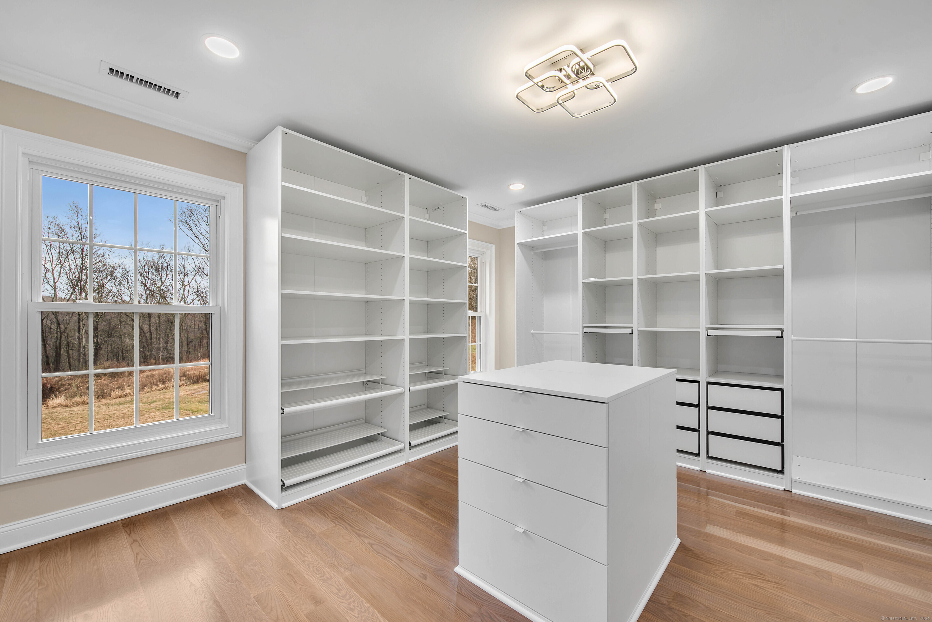 34 Fox Run Road Redding, CT 06896 - Photo 31 of 40 a view of an empty room with a window and wooden floor