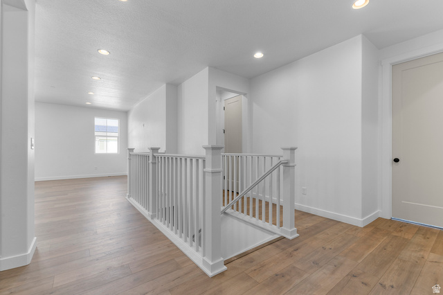 3016 West 2650 North Clinton, UT 84015 - Photo 7 of 20 Corridor with an upstairs landing, light wood-type flooring, and recessed lighting