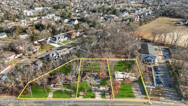 an aerial view of a residential houses with yard