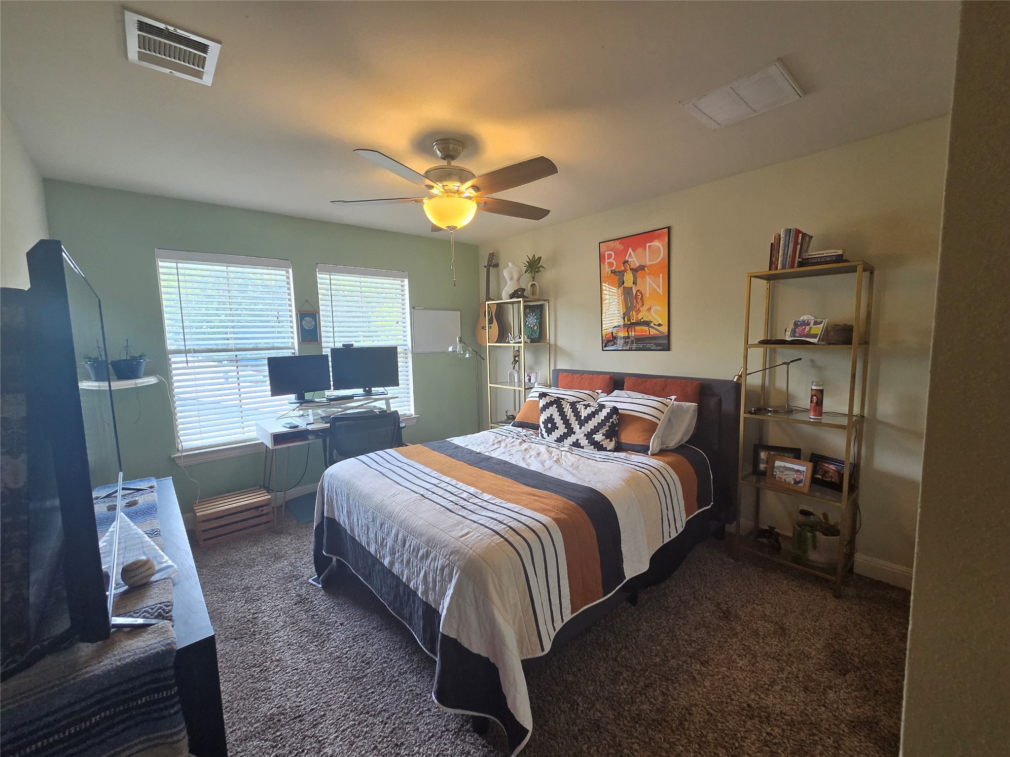 408 West Croslin Street Austin, TX 78752 - Photo 19 of 29 A comfortable bedroom with plush carpeting features ample natural light and a practical workspace.