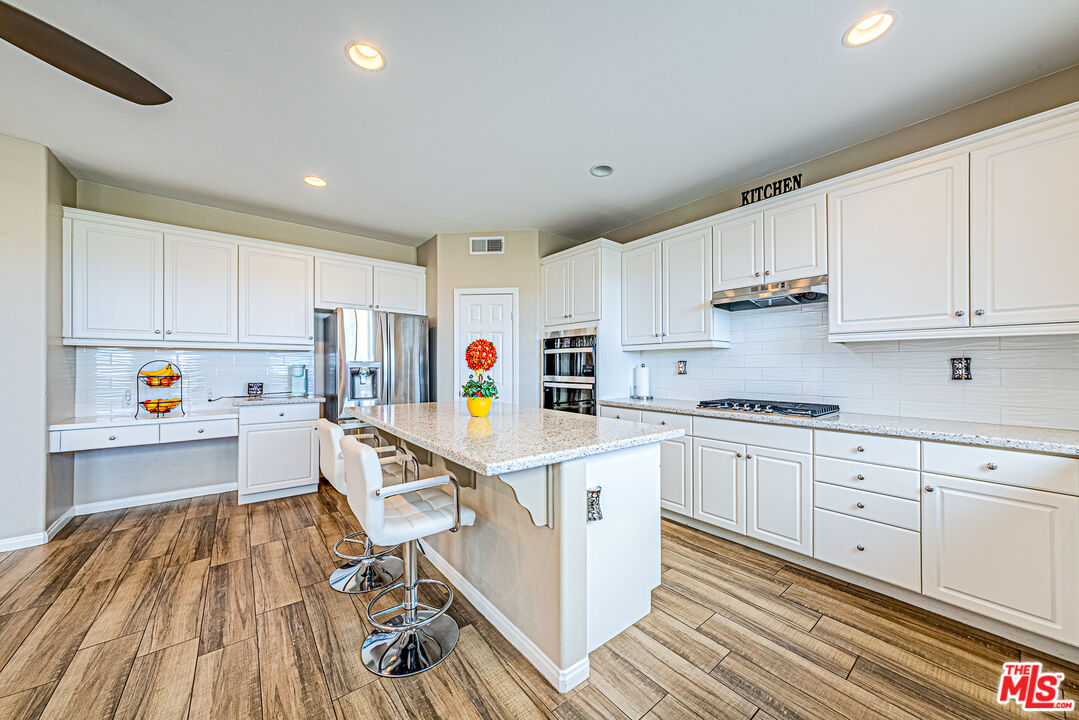 40918 Rise Court Palmdale, CA 93551 - Photo 12 of 45 a view of kitchen with wooden floor and electronic appliances