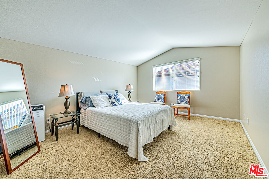 40918 Rise Court Palmdale, CA 93551 - Photo 39 of 45 a bedroom with a bed and a window